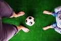 Father and son with soccer ball against green grass Royalty Free Stock Photo