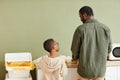 Father and Son Sorting Waste for Recycling