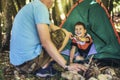 Father and son spending happy leisure time together outdoors in forest trees background Royalty Free Stock Photo