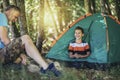 Father and son spending happy leisure time together outdoors in forest trees background Royalty Free Stock Photo