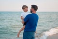 Father son spending time together sea vacation Young dad child little boy walking beach Royalty Free Stock Photo