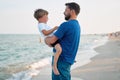 Father son spending time together sea vacation Young dad child little boy walking beach Royalty Free Stock Photo