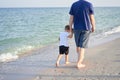 Father son spending time together sea vacation Young dad child little boy walking beach Royalty Free Stock Photo