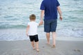 Father son spending time together sea vacation Young dad child little boy walking beach Royalty Free Stock Photo