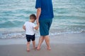 Father son spending time together sea vacation Young dad child little boy walking beach Royalty Free Stock Photo