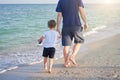 Father son spending time together sea vacation Young dad child little boy walking beach Royalty Free Stock Photo
