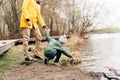 Father and son stand on the shore of the lake and playing with water. Happy family with child kid boy playing and having Royalty Free Stock Photo