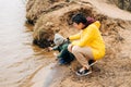 Father and son stand on the shore of the lake and playing with water. Happy family with child kid boy playing and having Royalty Free Stock Photo