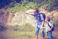 Father and son standing near the pond at the day time. Royalty Free Stock Photo