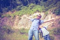 Father and son standing near the pond at the day time. Royalty Free Stock Photo