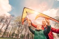 Father and son start to fly a kite in sky Royalty Free Stock Photo