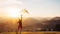 Father and son start to fly a kite together Royalty Free Stock Photo