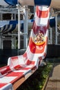Father and son on steep red and white waterslide Royalty Free Stock Photo
