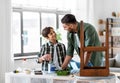 father and son stirring grey color paint at home Royalty Free Stock Photo