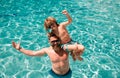 Father and son on summer weekend. Child with dad playing in swimming pool. Pool party. Sport activity. Royalty Free Stock Photo