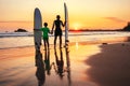 Father and son surfers meet a sunset on the ocean beach Royalty Free Stock Photo