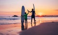 Father and son surfers stay on the sunset beach Royalty Free Stock Photo