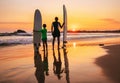 Father and son surfers stay on the sunset beach Royalty Free Stock Photo