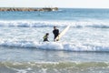 Father and son surfers in wetsuits in the sea Royalty Free Stock Photo