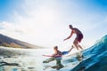 Father and Son Surfing, Riding Wave Together Royalty Free Stock Photo