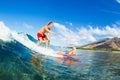 Father and Son Surfing, Riding Wave Together Royalty Free Stock Photo