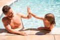 Father and son swimming in pool, summer family. Child with dad playing in swimmingpool. Family time. Summer vacation