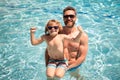 Father and son swimming in pool, summer family vacation. Pool party. Child with dad playing in swimming pool. Active Royalty Free Stock Photo