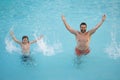Father and son in swimming pool on summer vacation. Child with dad playing in pool. Dad and kid in pool at summer day Royalty Free Stock Photo