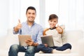 Father and son with tablet pc showing thumbs up Royalty Free Stock Photo