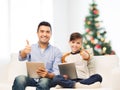 Father and son with tablet pc showing thumbs up Royalty Free Stock Photo