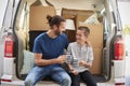 Father And Son Take A Break In Back Of Removal Van On Moving Day Royalty Free Stock Photo