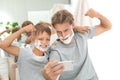 Father and son taking selfie with shaving foam on faces Royalty Free Stock Photo