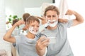 Father and son taking selfie with shaving foam on faces Royalty Free Stock Photo