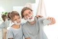 Father and son taking selfie with shaving foam on faces Royalty Free Stock Photo