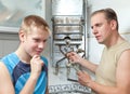 Father and son-teenager together in repair heater