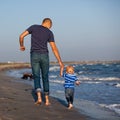 Father and son to the sea at sunset