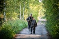 Father and son together hunting together. Walking the road in a forest. Royalty Free Stock Photo