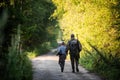 Father and son together hunting together. Walking the road in a forest. Royalty Free Stock Photo