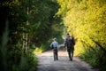 Father and son together hunting together. Walking the road in a forest. Royalty Free Stock Photo