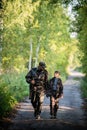 Father and son together hunting together. Walking the road in a forest. Royalty Free Stock Photo