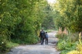 Father and son together hunting together. Walking the road in a forest. Royalty Free Stock Photo