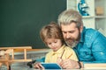 Father and son together schooling. Pupil learning letters and numbers. Teacher and pupil. Private kids tutoring Royalty Free Stock Photo