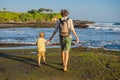 Father and son tourists on the background of Tanah Lot - Temple Royalty Free Stock Photo