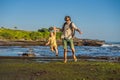 Father and son tourists on the background of Tanah Lot - Temple Royalty Free Stock Photo