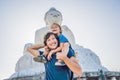 Father and son tourists on the Big Buddha statue. Was built on a