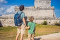 Father and son tourists enjoying the view Pre-Columbian Mayan walled city of Tulum, Quintana Roo, Mexico, North America Royalty Free Stock Photo