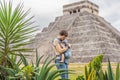 Father and son tourists observing the old pyramid and temple of the castle of the Mayan architecture known as Chichen