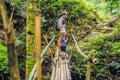 Father and son travelers on the suspension bridge in Bali. Traveling with children concept. Royalty Free Stock Photo