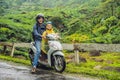 Father and son are traveling on a moped on a tea plantation in Malaysia. Traveling with children concept Royalty Free Stock Photo