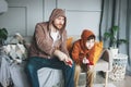 Father and son tween boy in hoodies playing computer games with joystick at home tipical caucasian family Royalty Free Stock Photo